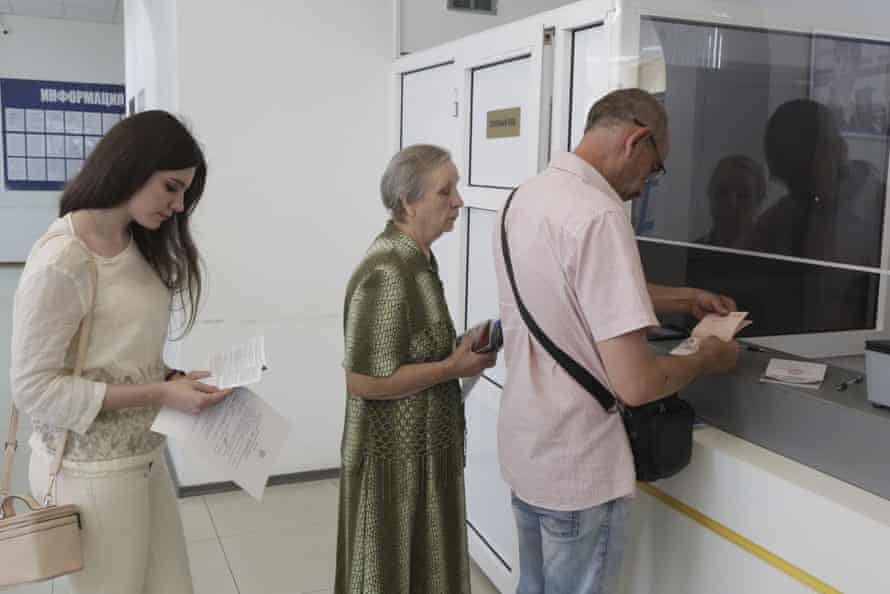 Residents of Donetsk stand in line at a migration service office to receive a passport of a citizen of the Russian Federation, in Donetsk, in an area controlled by Russian-backed separatist forces, eastern Ukraine.