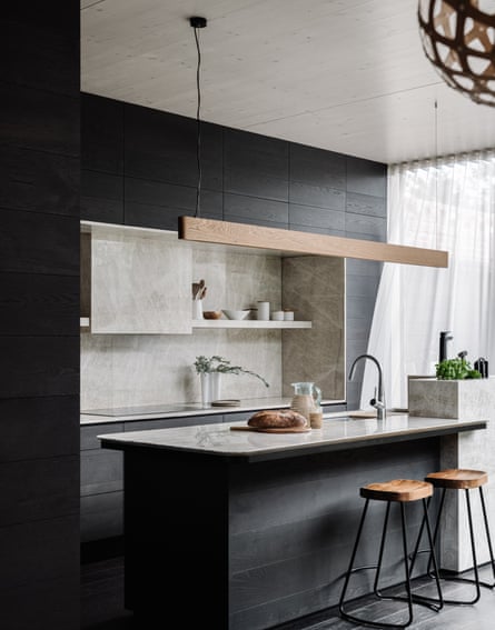 The kitchen features black-stained American oak and marble surfaces.