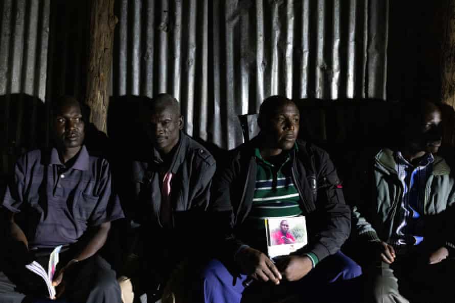 Samuel Kimonge holds a booklet commemorating the life of his brother Bernad Mogaka