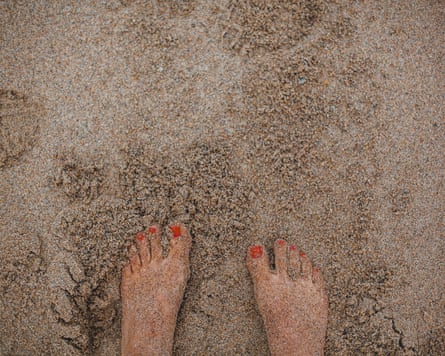 Female feet on sand