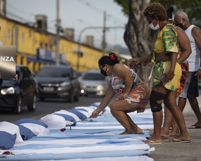 Residents place flowers on mattresses with roses symbolising those who have died of Covid-19, during a protest against the Brazilian government’s handling of the pandemic, organised by the Rio de Paz NGO, in front of the Ronaldo Gazolla hospital in Rio de Janeiro.