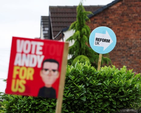 Campaign placards for Labour and Reform UK in Makerfield