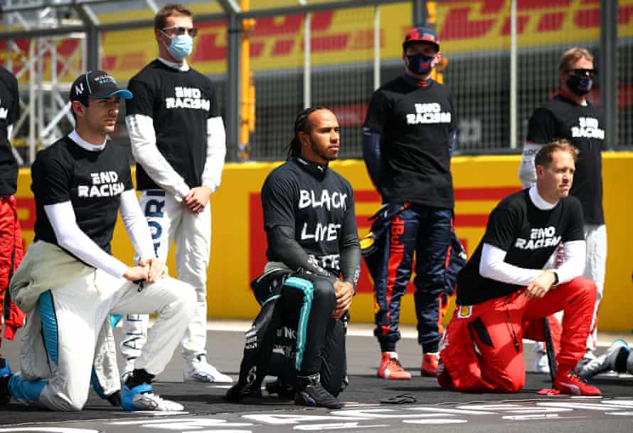 Protest at oppression ... Hamilton takes a knee on the grid in support of Black Lives Matter at Silverstone in August 2020.