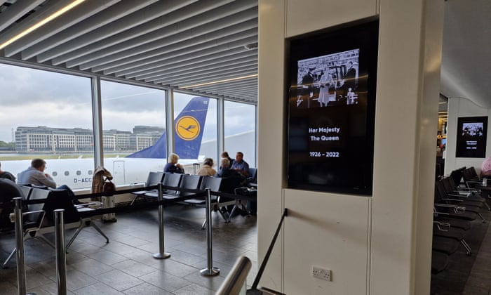 A screen displays a tribute at London City Airport this morning