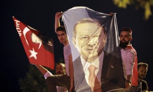 Men hold a banner with a picture of of Recep Tayyip Erdogan in Istanbul.