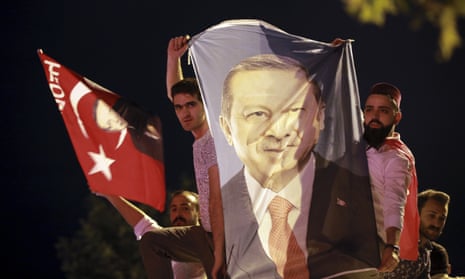 Men hold a banner with a picture of of Recep Tayyip Erdogan in Istanbul. 