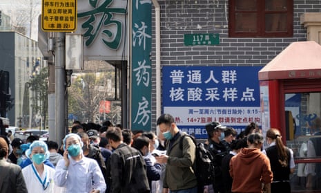 Residents line up outside a nucleic acid testing site of a hospital in Shanghai.
