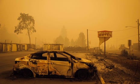 A charred vehicle in the parking lot of the Oak Park Motel, near Gates, Oregon. At least 50 fires have burned over 800 sq miles across the state.