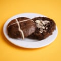 An Iceland Luxury extremely chocolatey hot cross bun, sliced, toasted and buttered, on a white plate