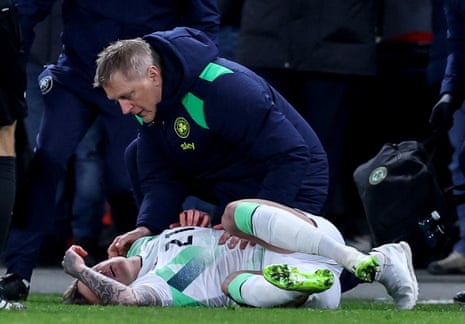 Ireland’s head coach Heimir Hallgrímsson checks on Sammie Szmodics.