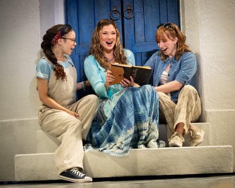 three people sit on stoop in front of doorway