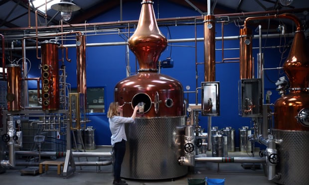 Kit Clancy, an assistant distiller, refills a copper pot still at the Sipmsith gin distillery in London.