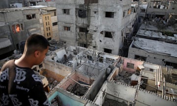 Palestinians inspect houses damaged in an Israeli strike in rafah