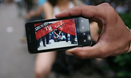 A demonstrator shows a photograph of himself being arrested during the second week of the Occupy encampment.