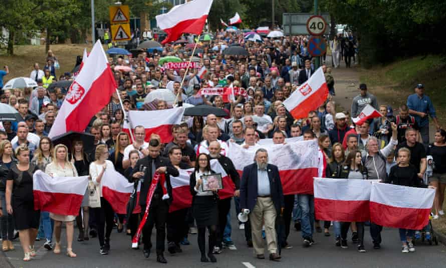 Members of the Polish community march through Harlow
