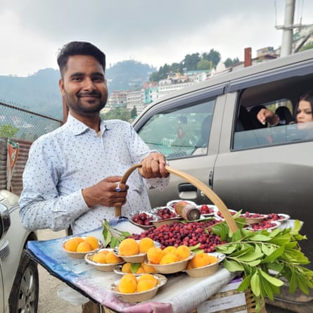 Fruit seller Rohit Kumar sells his wares to tourists in traffic jams in Mussoorie.