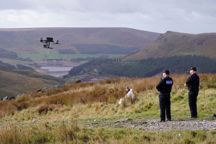Police launch a drone to aid the search on Saddleworth Moor.