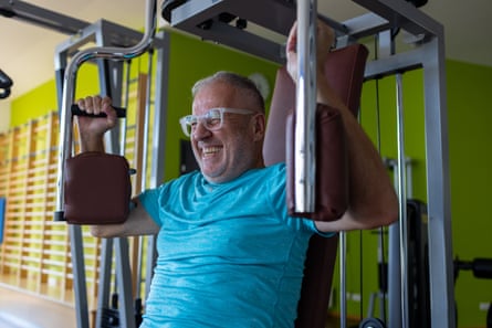 Mature man exercising with equipment in gymActive senior exercising with equipment in gym. Active seniors, vitality and wellbeing concept