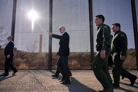 Biden walking along a border fence