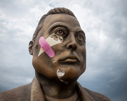 A damaged statue of Elon Musk.