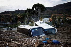 Damaged buses lie among debris following a landslide on the holiday island of Ischia, Italy