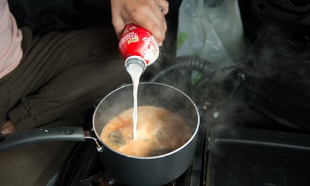 Gurpreet Singh’s co-driver Vikram prepares chai for Singh en route to Bakersfield to drop off cargo.