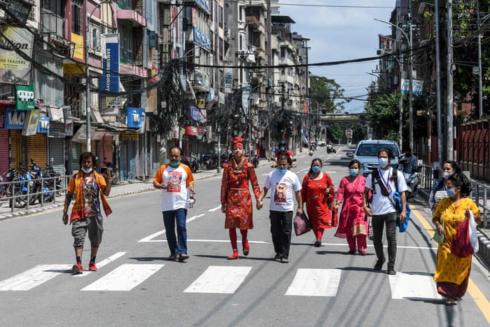 A devotee dressed as Hindu deity Ganesh walks with a few other devotees on an empty street in Kathmandu, Nepal, as large gatherings are restricted due to coronavirus measures, for the annual Indra Jatra festival, on 30 August, 2020. The eight-day long festival ‘Indra Jatra’ celebrates the Hindu king of gods and god of rains Indra and is also usually marked by the Kumari Jatra, the religious procession of the living goddess Kumari.