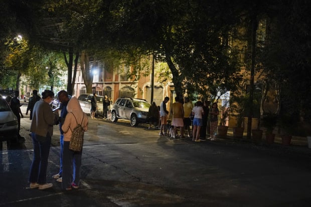 Residents gather outside in the early morning in Mexico.