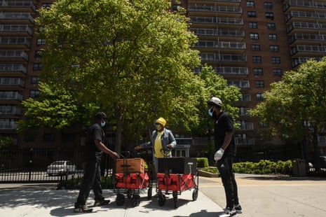 An employee of Collective Fare drops off donation meals in the Brownsville neighborhood of Brooklyn. Brownsville has had its problems with gun violence and police brutality.