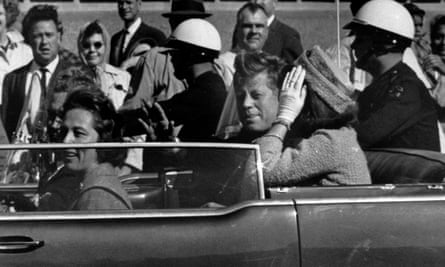 President John F. Kennedy sits in his motorcade about a minute before he is shot dead in Dallas, Texas, in November 1963.