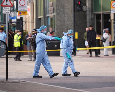Investigators in PPE at the scene, which has been cordoned off