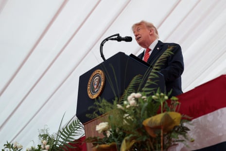 Trump speaking on stage.
