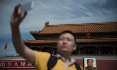 A man takes a selfie with his smartphone in front of a giant portrait of Mao Zedong at the gate of the Forbidden City in Beijing on 9 September 2016, the 40th anniversary of the death of Communist China’s founding father.