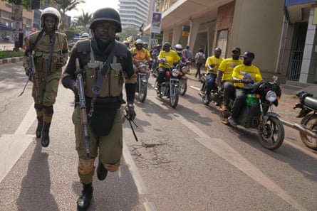 Security forces patrol a street in Kampala as supporters of Yoweri Museveni celebrate his victory.