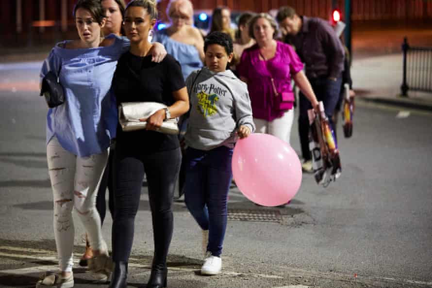 Police leads parents and their children away from Manchester Arena where two suspected bomb explosions are reported to have killed at least 19 concert goers as they left a performance by Ariana Grande.