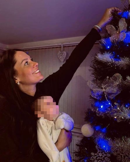 Kiena Dawes and her baby daughter next to Christmas tree