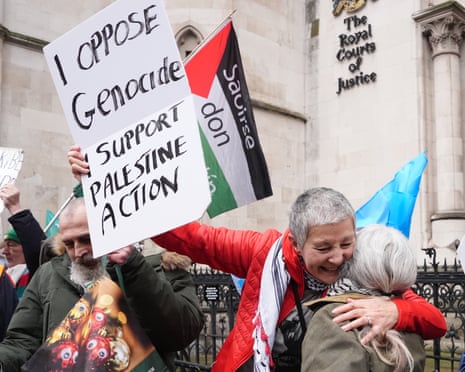 Protesters hug in celebration outside the high court.