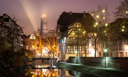 spire, half-timbered buildings and canal at night