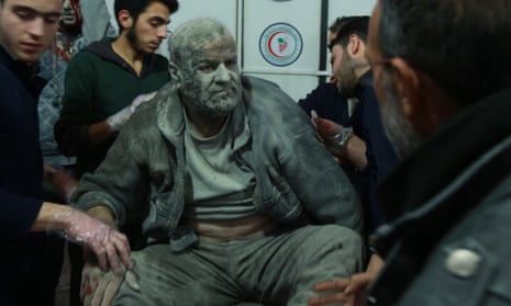 A wounded Syrian man saved from the rubble arrives at a makeshift hospital in eastern Ghouta.