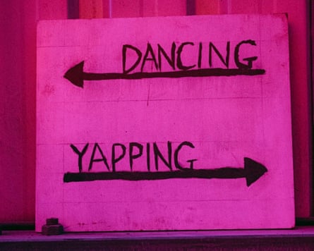A handwritten sign saying dancing with an arrow pointing the left and yapping with an arrow pointing to the right