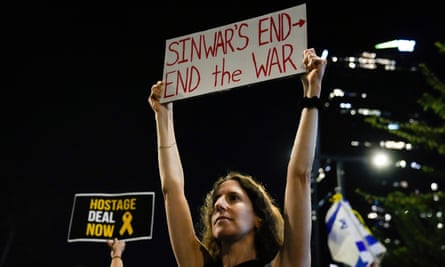 A demonstrator holds a sign that says Sinwar's End, End the War