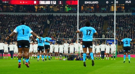 England players look on as the Fiji players perform the cibi.