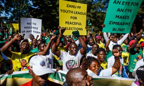 Activists from the youth arm of the ruling Zanu-PF party attend a rally in Harare, Zimbabwe