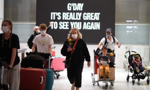 Families walk out of the arrivals hall at Sydney’s International Airport on 1 November, 2021, as Australia’s international border reopened almost 600 days after a pandemic closure began.