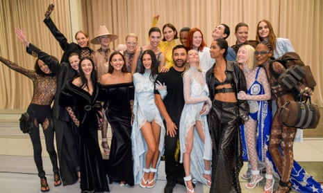 Riccardo Tisci poses backstage with models