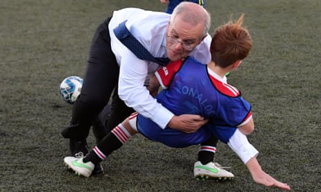 Scott Morrison crash tackles a child at the Devonport Strikers Soccer Ground. 