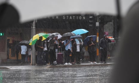 Pedestrians hold umbrellas during wet weather in Sydney