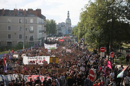 French students with protest signs fill a street during a demonstration in Nantes