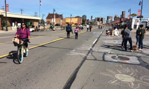 Detroit residents cycle and walk on the city’s temporarily traffic-free streets