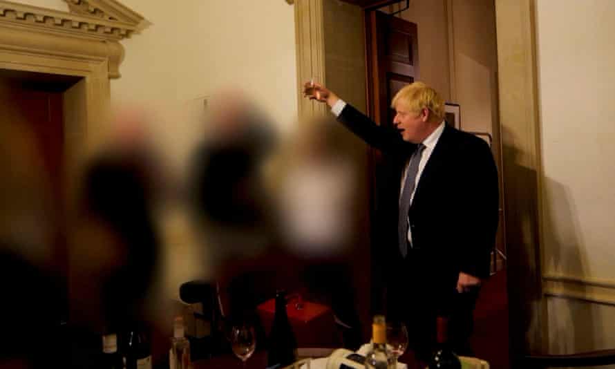 Boris Johnson seen raising a glass during a Downing Street leaving do with adviser Lee Cain.